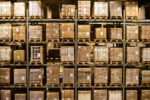 A large warehouse storage area filled with stacked pallets and boxes. The shelves are organized and labeled, indicating efficient inventory management.