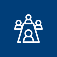 Icon of four people sitting around a conference table, symbolizing a meeting or group discussion.